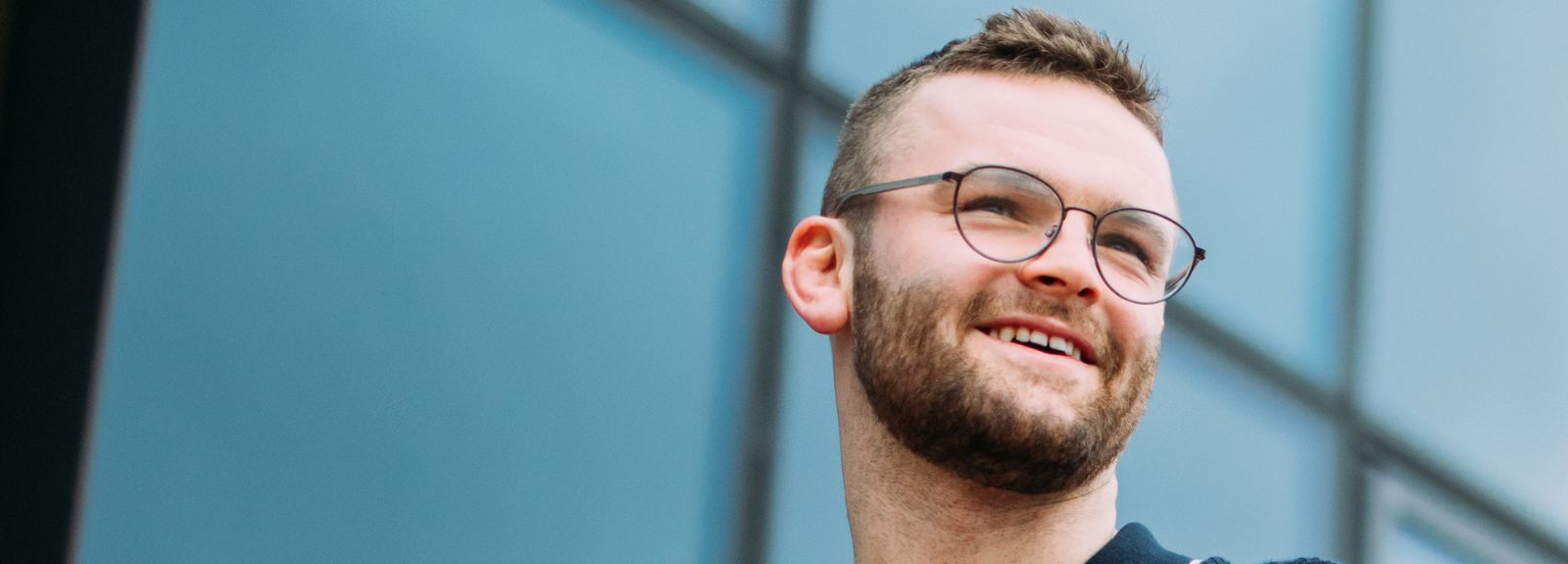male student looking sideways and smiling
